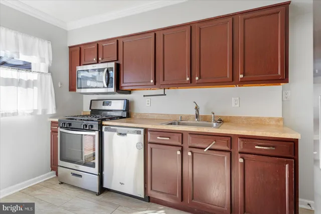 a kitchen with stainless steel appliances granite countertop a sink stove and microwave