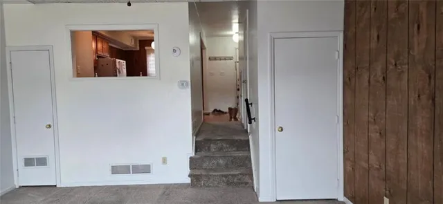 a view of a hallway with wooden shelves