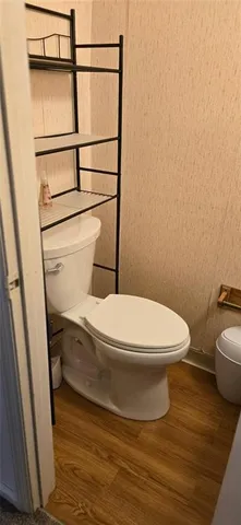 a white toilet sitting next to a small sink