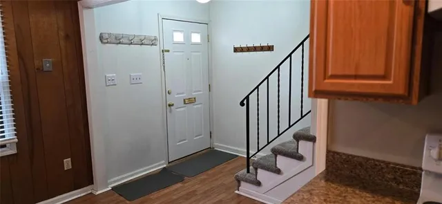 a view of entryway with wooden floor and stairs