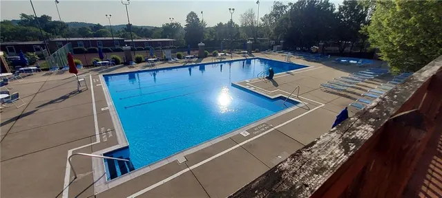 a view of swimming pool with outdoor seating