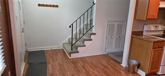 a view of entryway and hall with wooden floor