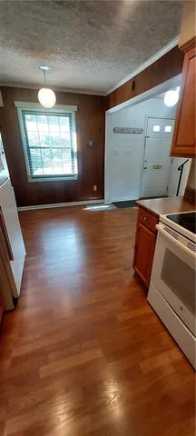 a view of a room with wooden floor and window