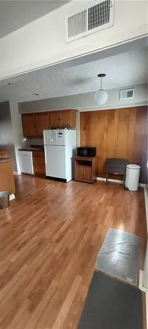 a view of room with furniture and wooden floor