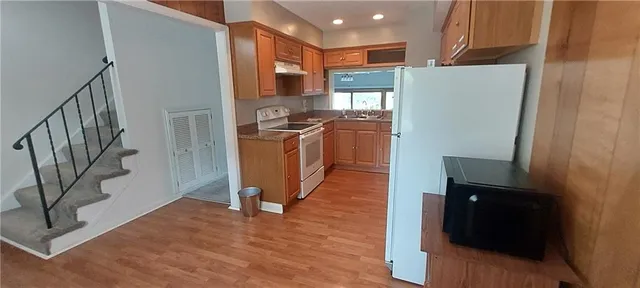 a view of living room with furniture and wooden floor