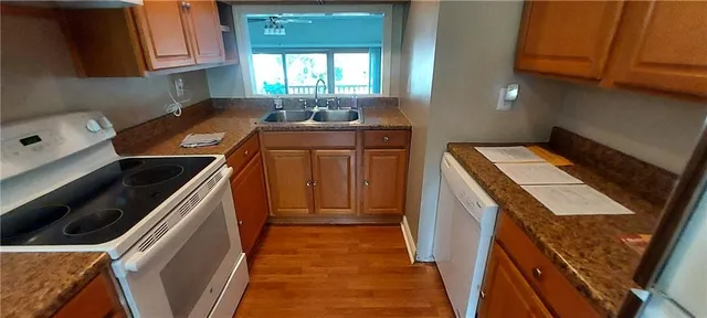 a kitchen with a sink a stove and cabinets