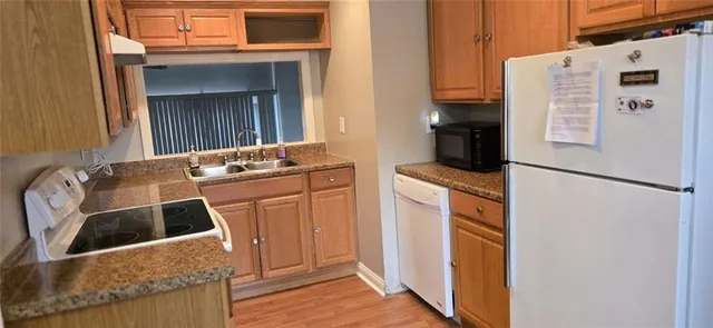 a kitchen with a refrigerator sink and stove