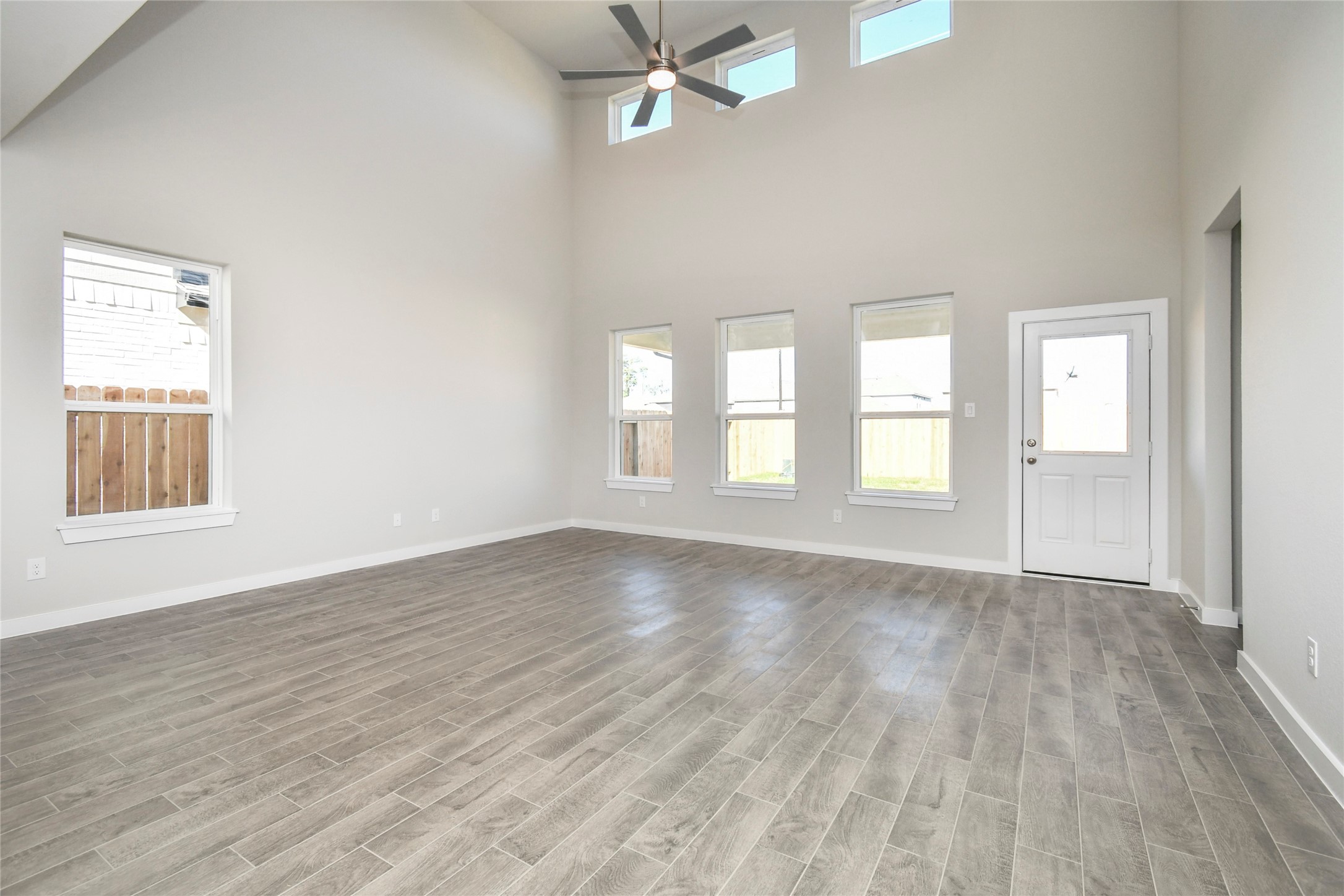 15119 Statice Trail Houston, TX 77044 - Photo 14 of 26 an empty room with wooden floor windows and fan