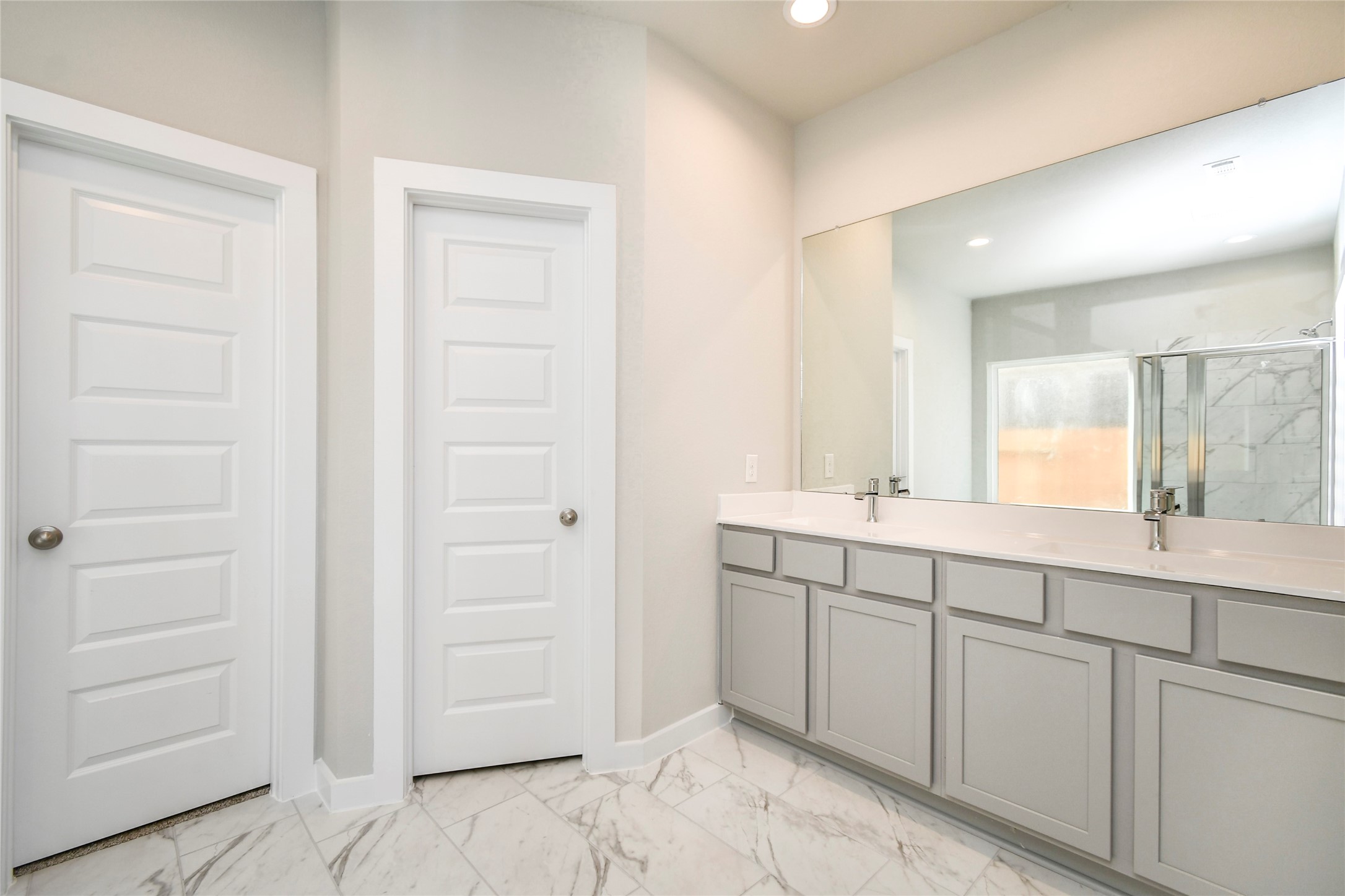 15119 Statice Trail Houston, TX 77044 - Photo 18 of 26 a spacious bathroom with a double vanity sink a mirror and a