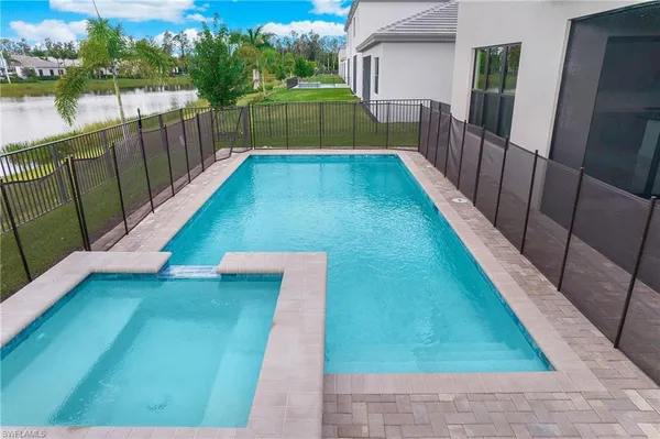 a view of a backyard with swimming pool