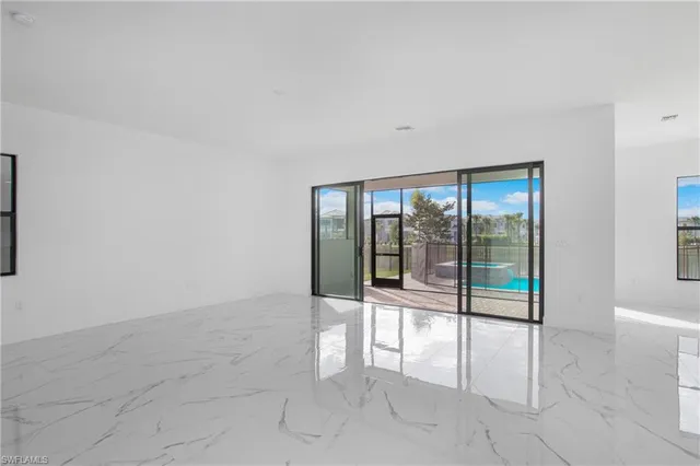 an empty room with sliding glass door and shower