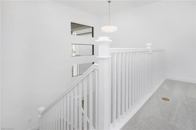 a view of a hallway with stairs