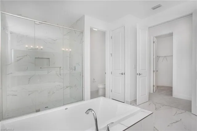a bathroom with a bathtub and shower