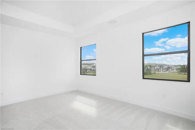 an empty room with a painting on the wall