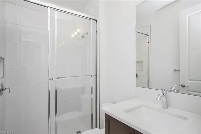 a bathroom with a shower and a sink
