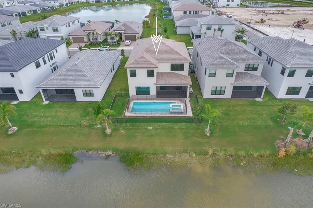 an aerial view of residential houses with outdoor space and parking