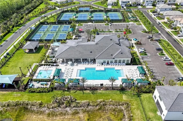 an aerial view of a house with a garden and lake view