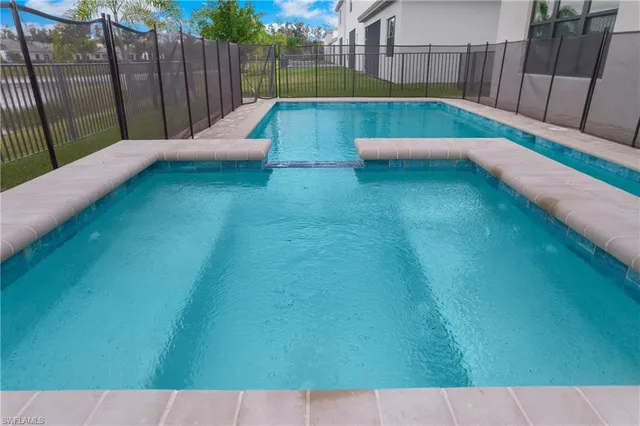 a view of a backyard with wooden fence