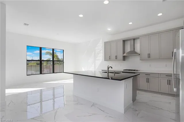 a kitchen with stainless steel appliances granite countertop a stove and a sink