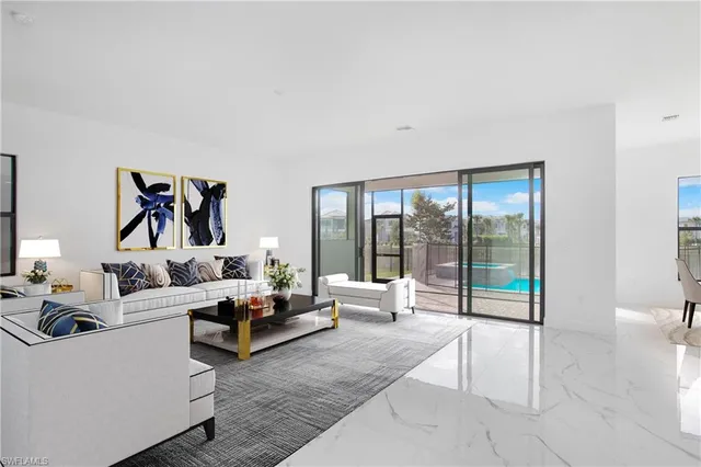 a living room with furniture large windows and a rug