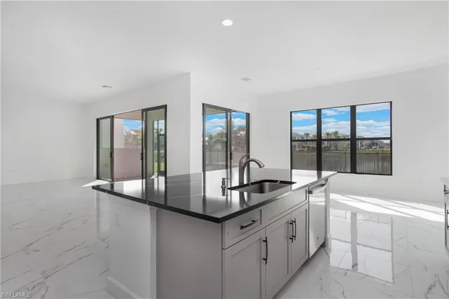 a kitchen with granite countertop a sink and a counter top space