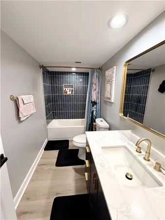 a spacious bathroom with a tub double vanity and window