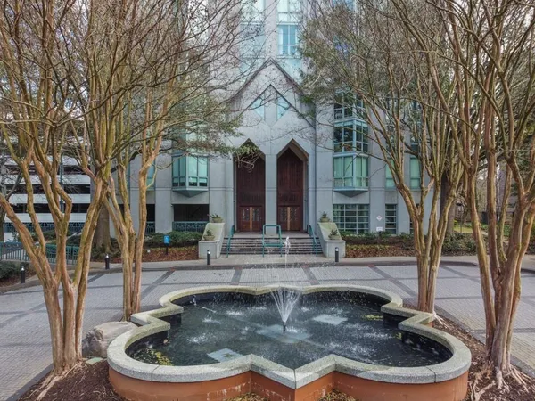 a view of a house with fountain in front of house