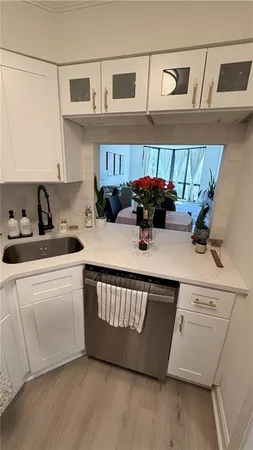 a kitchen with a sink a stove and cabinets