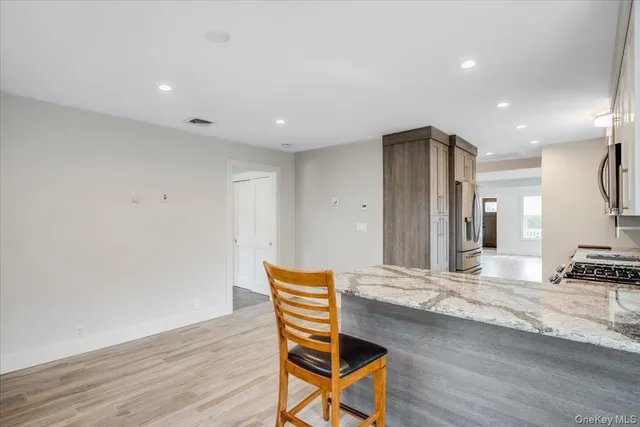 a living room with a wooden floor and a flat screen tv
