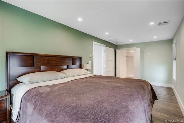 a bedroom with a large bed and a large window