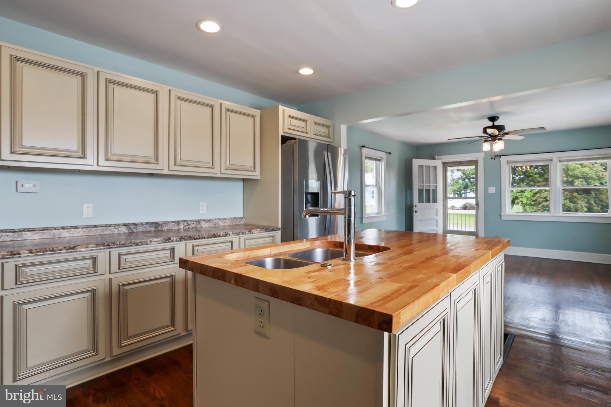 217 Poorhouse Road Winchester, VA 22603 - Photo 13 of 39 a kitchen with stainless steel appliances granite countertop a sink and dishwasher with wooden floor