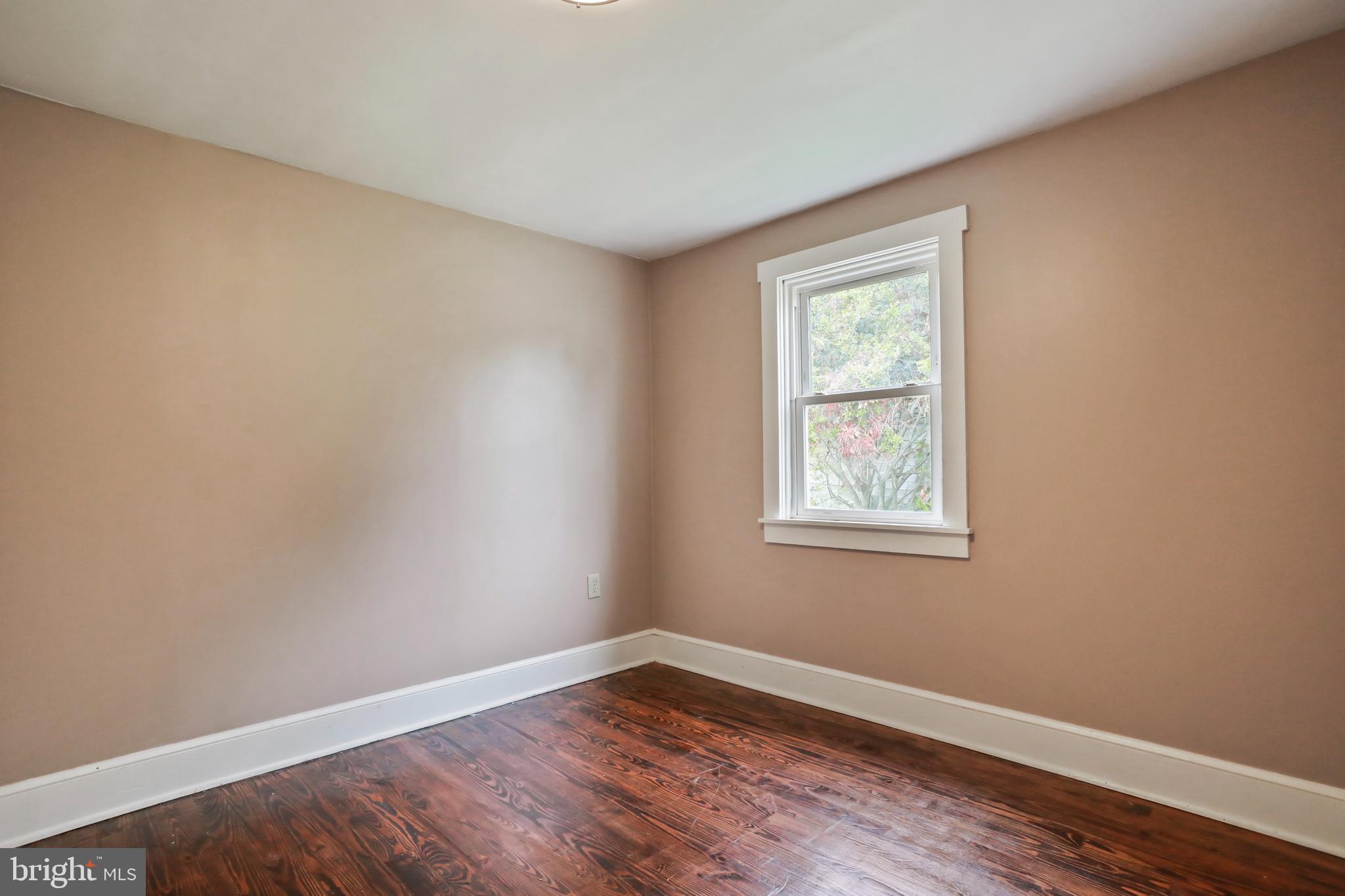 217 Poorhouse Road Winchester, VA 22603 - Photo 15 of 39 a view of an empty room with wooden floor and a window