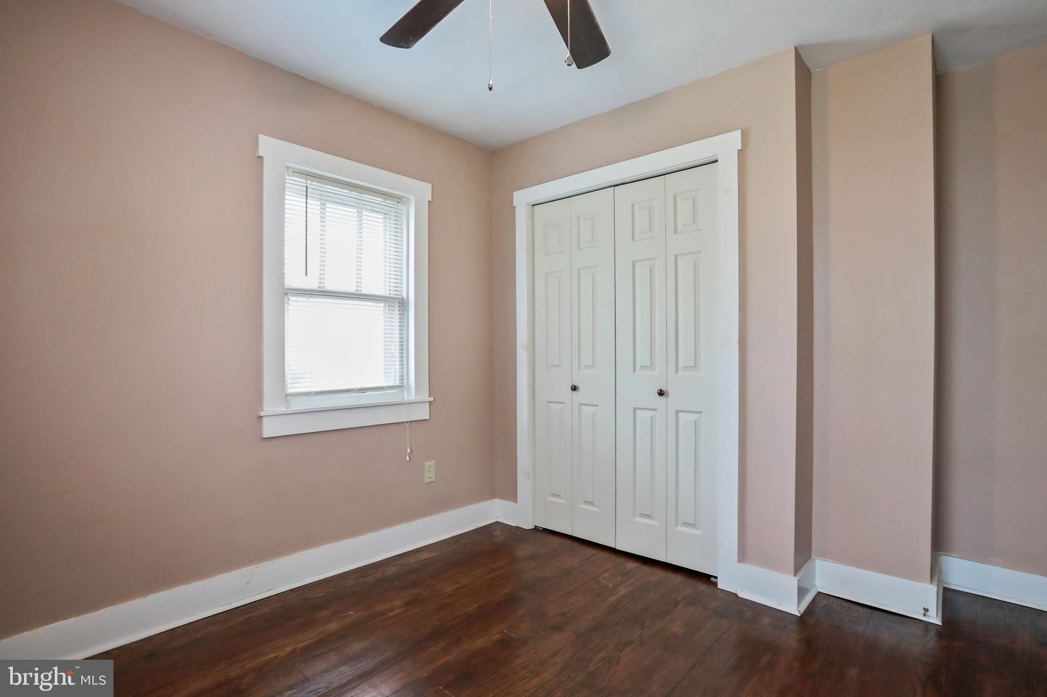 217 Poorhouse Road Winchester, VA 22603 - Photo 19 of 39 an empty room with wooden floor cabinet and windows