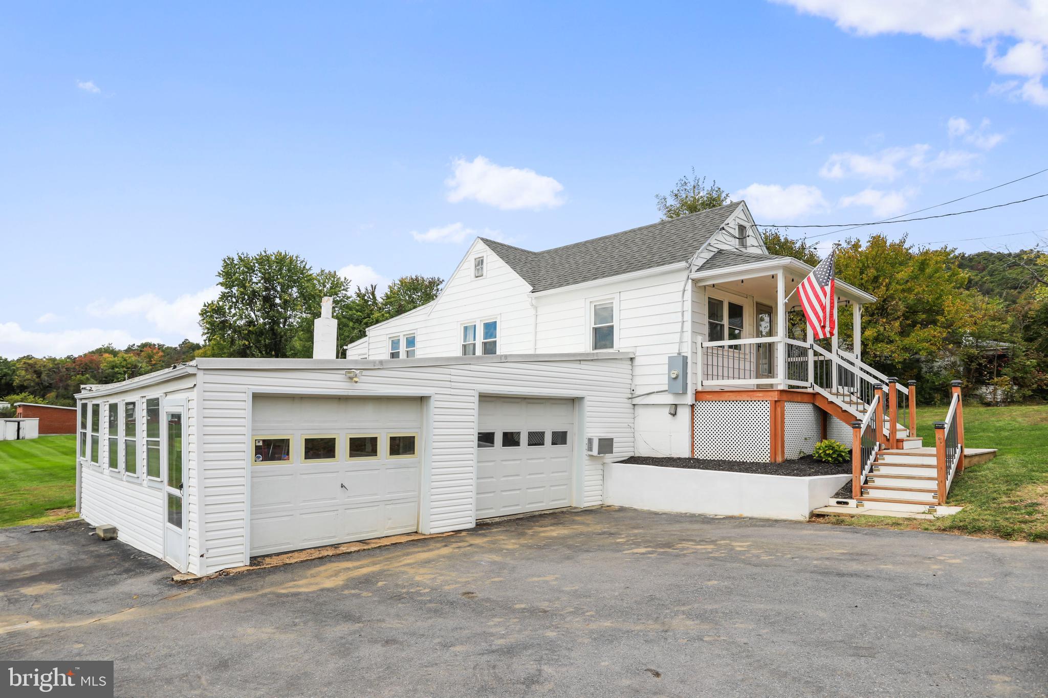 217 Poorhouse Road Winchester, VA 22603 - Photo 2 of 39 a view of a white house with a big yard and large trees