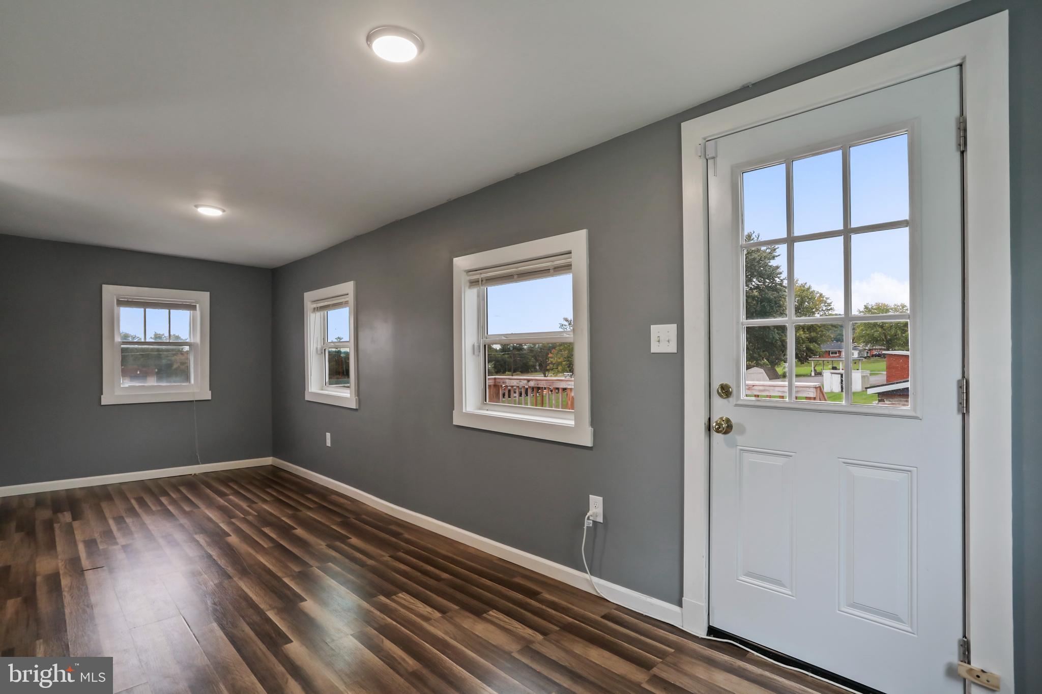 217 Poorhouse Road Winchester, VA 22603 - Photo 28 of 39 a view of an empty room with wooden floor and a window