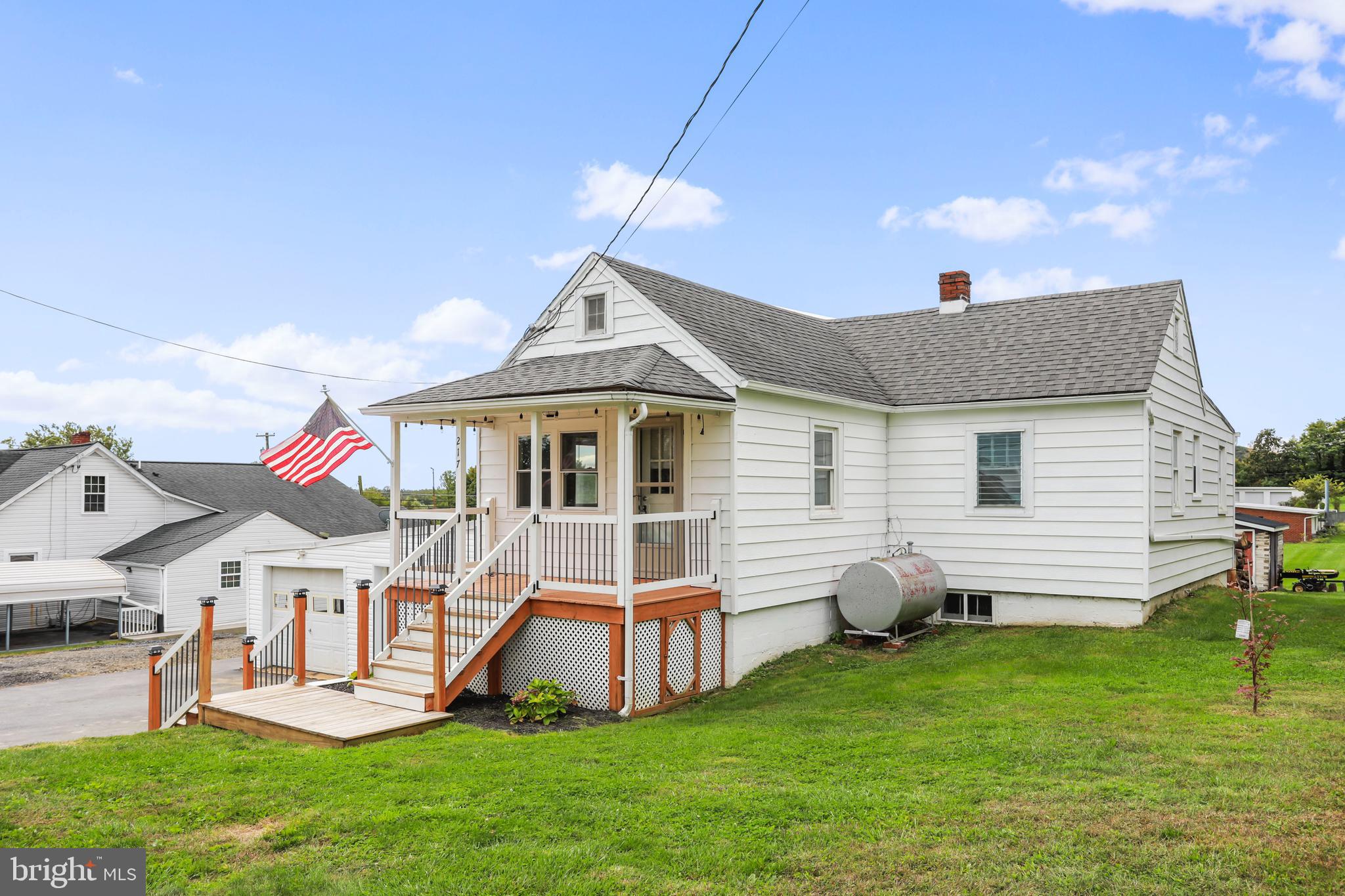 217 Poorhouse Road Winchester, VA 22603 - Photo 3 of 39 a front view of house with a garden and deck