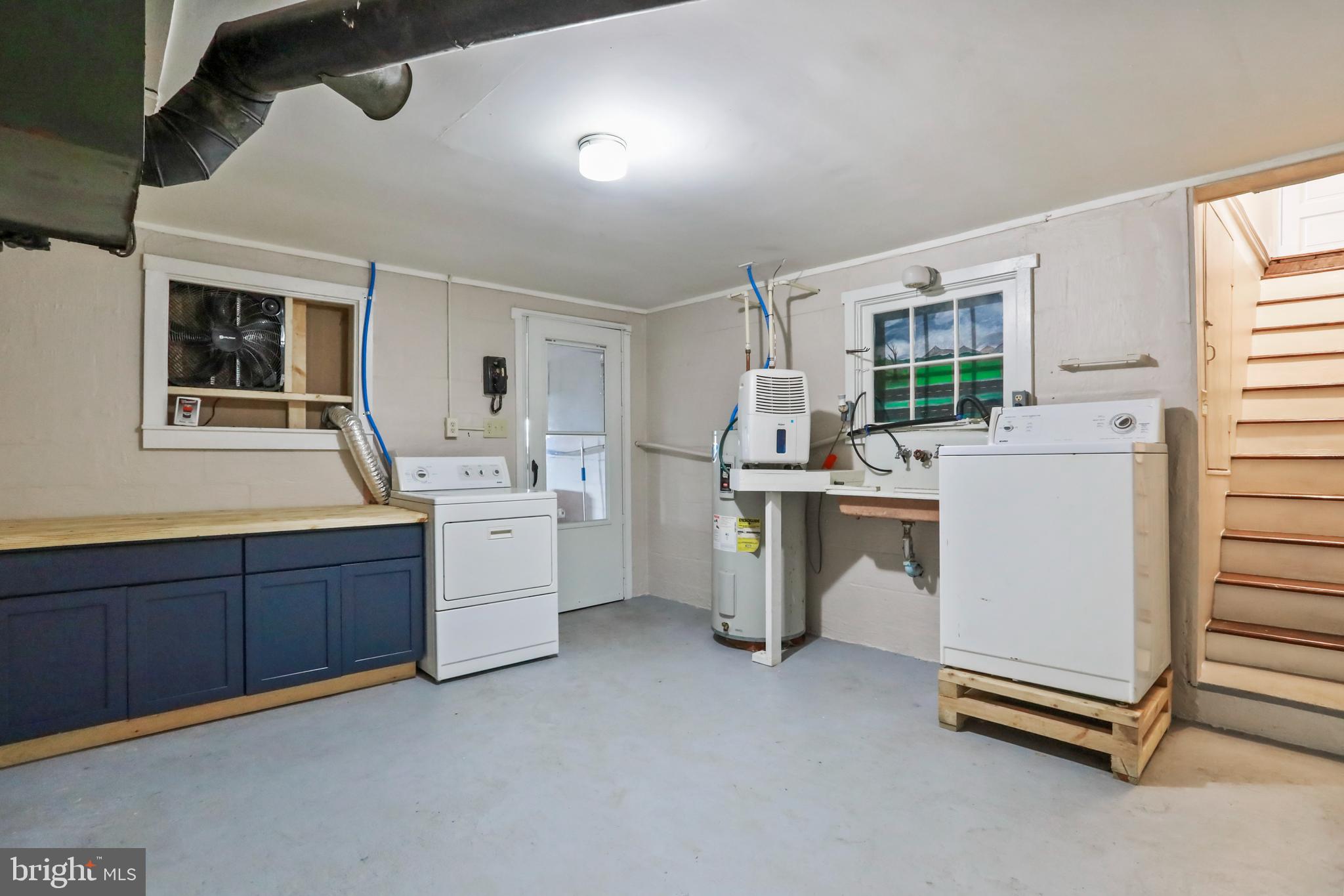 217 Poorhouse Road Winchester, VA 22603 - Photo 32 of 39 a kitchen with sink cabinets and window