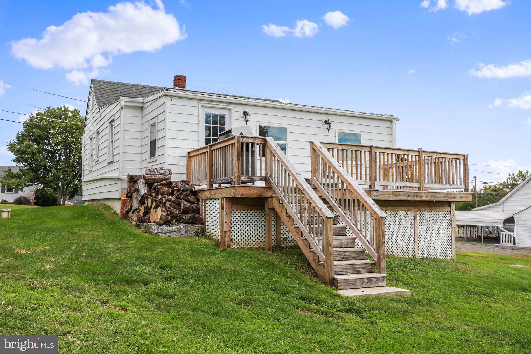 217 Poorhouse Road Winchester, VA 22603 - Photo 34 of 39 a view of a house with a yard and deck