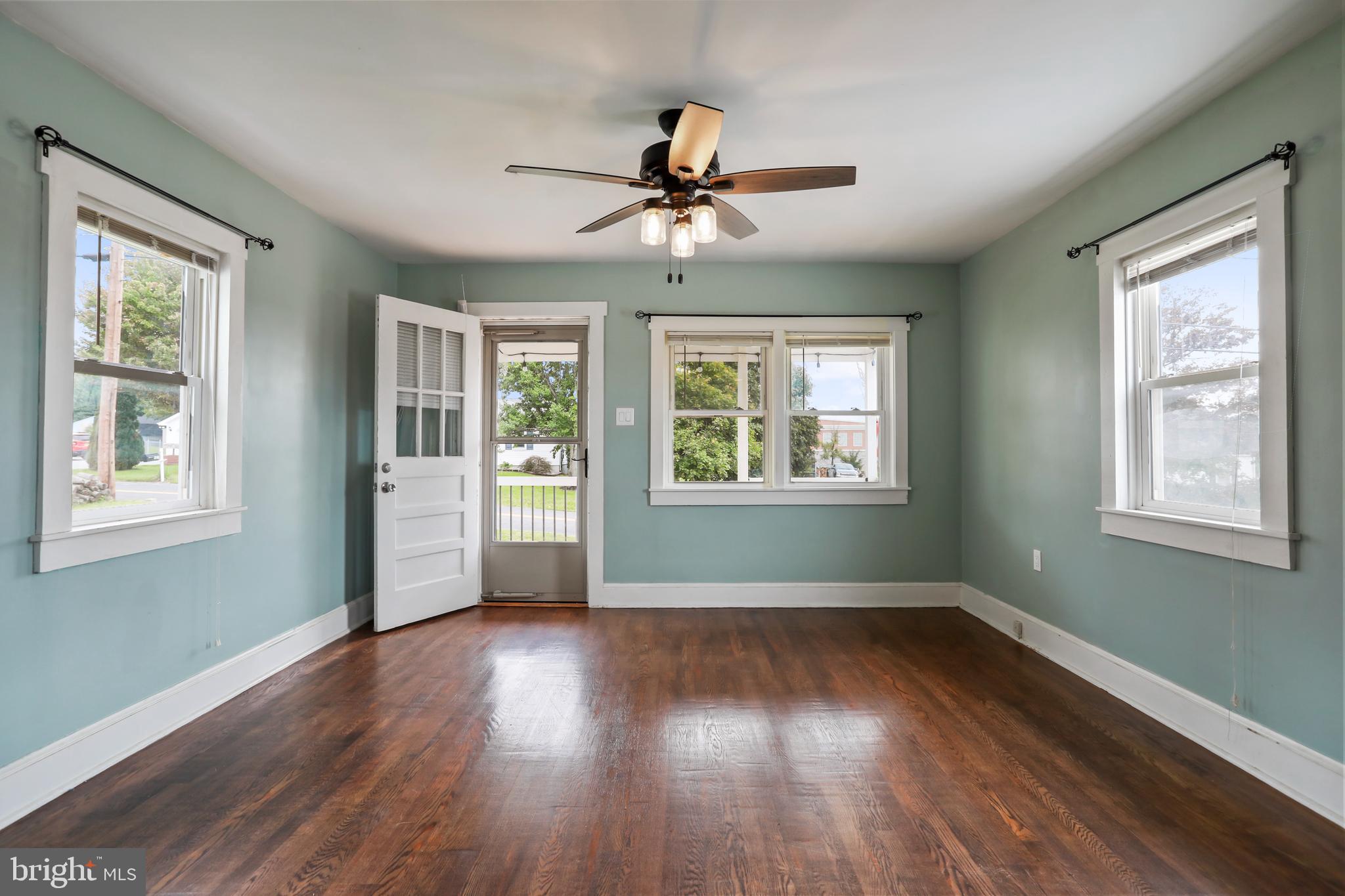 217 Poorhouse Road Winchester, VA 22603 - Photo 4 of 39 a view of an empty room with wooden floor and a window
