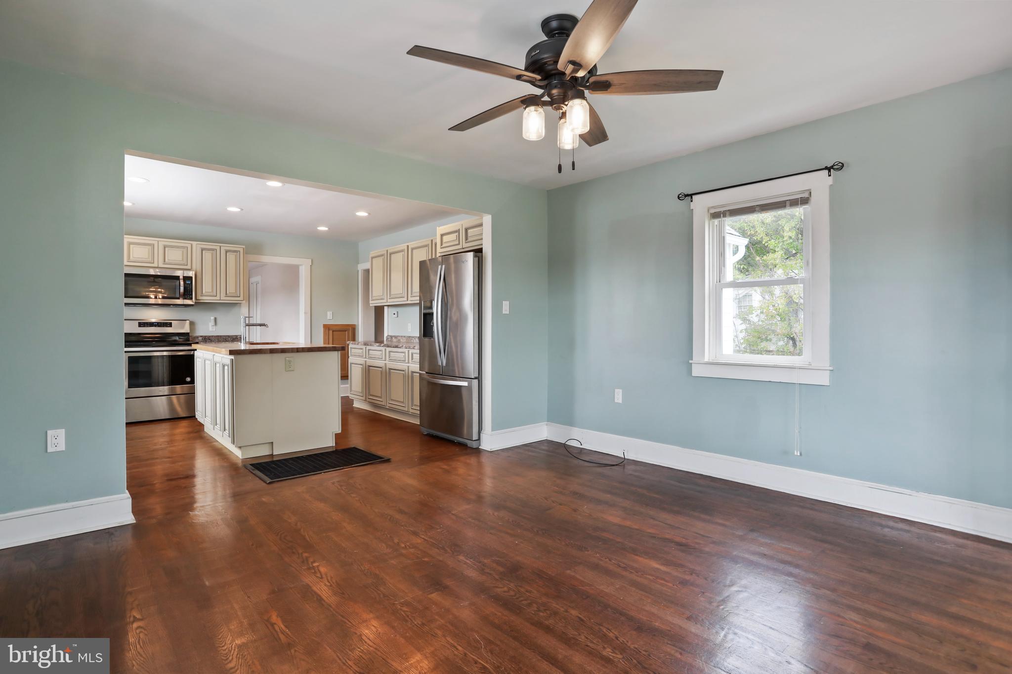 217 Poorhouse Road Winchester, VA 22603 - Photo 6 of 39 a view of a kitchen with a microwave and a ceiling fan