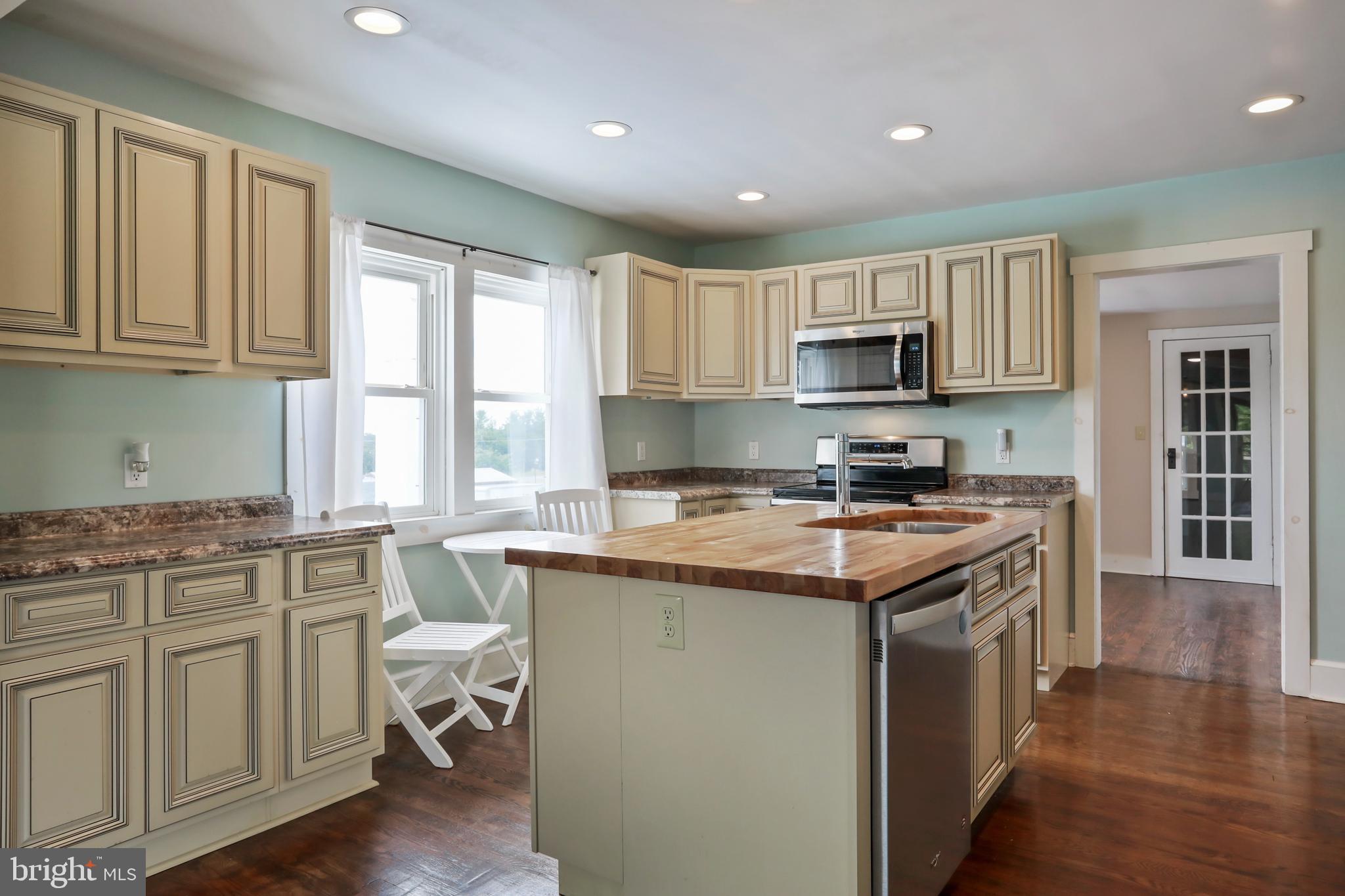217 Poorhouse Road Winchester, VA 22603 - Photo 8 of 39 a kitchen with granite countertop a stove top oven sink and cabinets