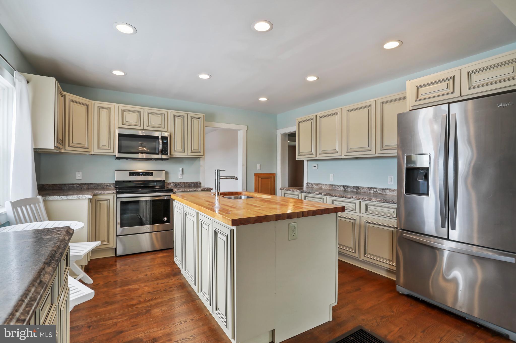 217 Poorhouse Road Winchester, VA 22603 - Photo 10 of 39 a kitchen with kitchen island granite countertop stainless steel appliances and wooden cabinets