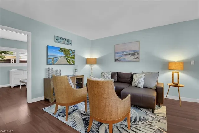 a living room with furniture and a lamp