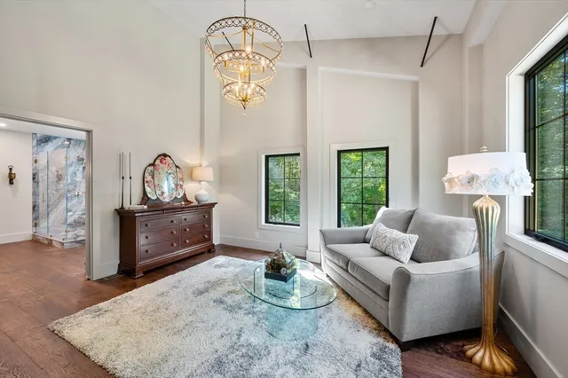 a bathroom with a granite countertop sink a toilet a mirror and shower