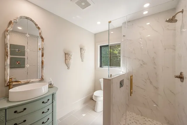 a media room with large window and furniture