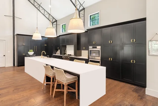 a living room with furniture and a kitchen view