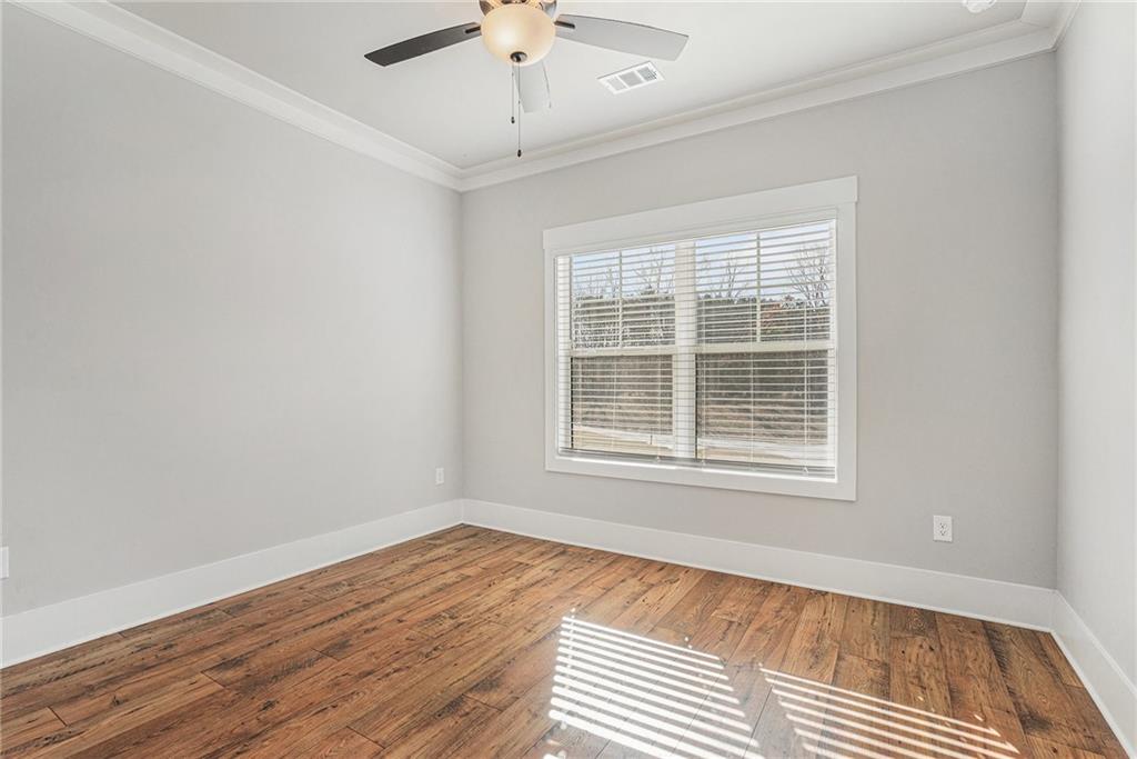 1119 Heights View Way Monroe, GA 30655 - Photo 13 of 30 an empty room with wooden floor and windows