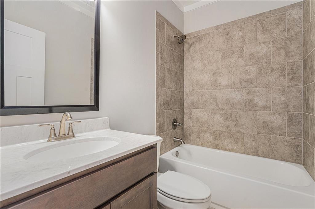 1119 Heights View Way Monroe, GA 30655 - Photo 16 of 30 a bathroom with a granite countertop bathtub shower sink vanity mirror and toilet