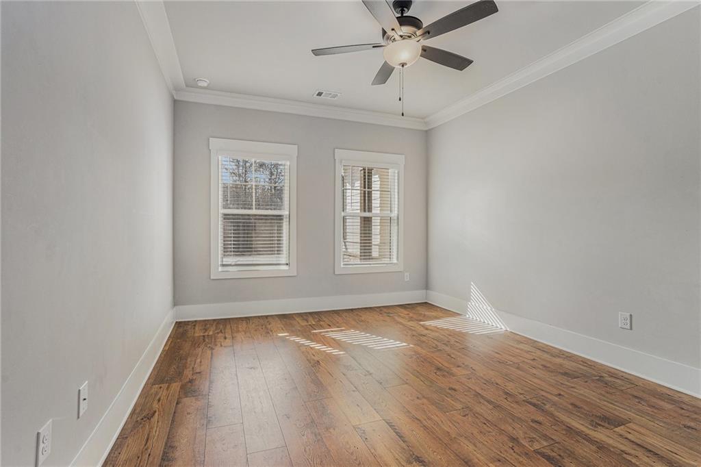 1119 Heights View Way Monroe, GA 30655 - Photo 19 of 30 a view of an empty room with wooden floor and a window