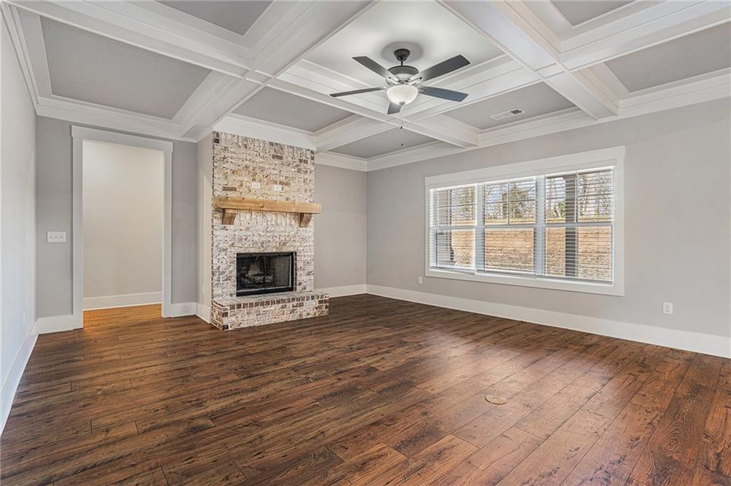 1119 Heights View Way Monroe, GA 30655 - Photo 2 of 30 a view of an empty room with wooden floor fireplace and a window